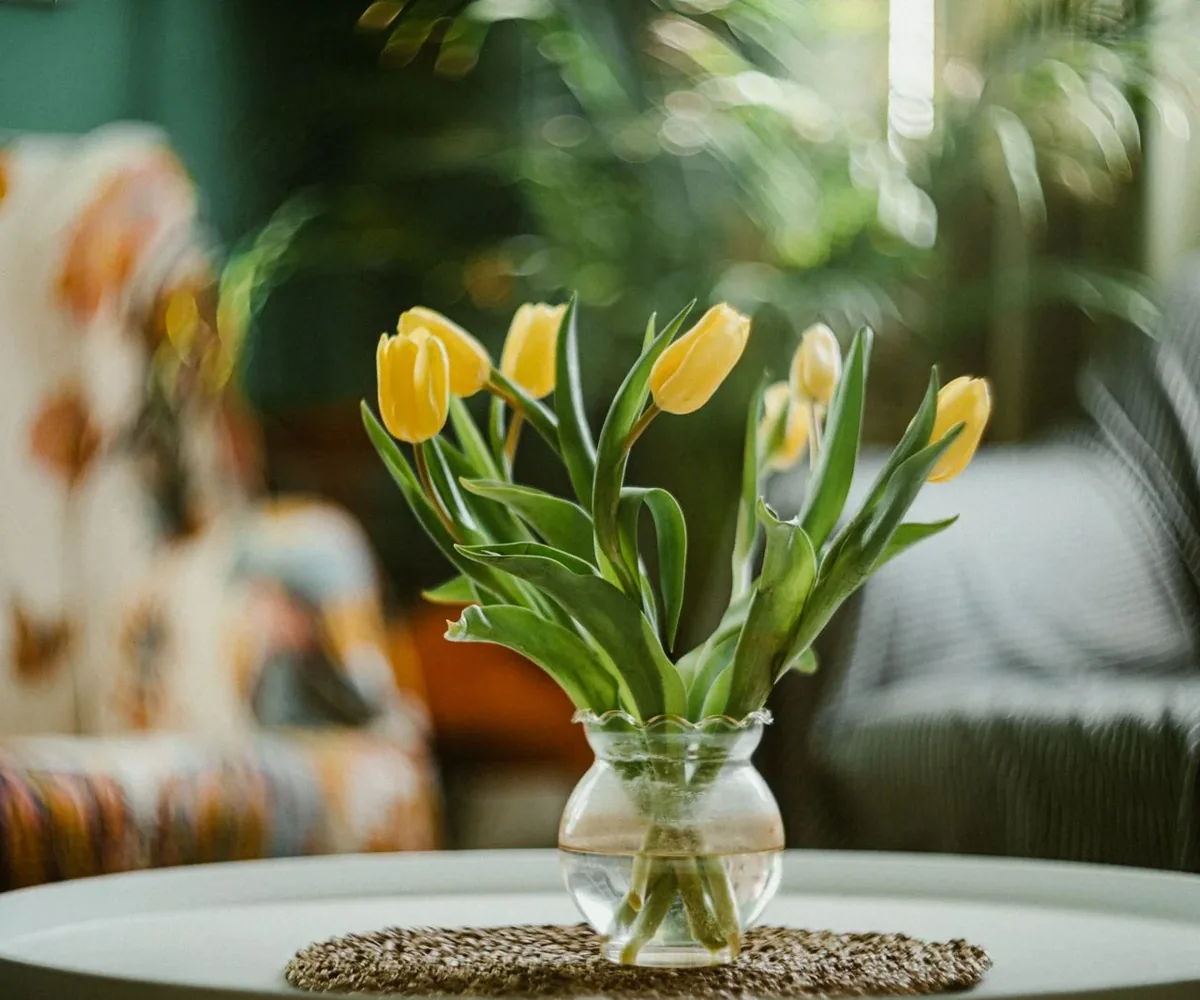 A vase of fresh yellow tulips
